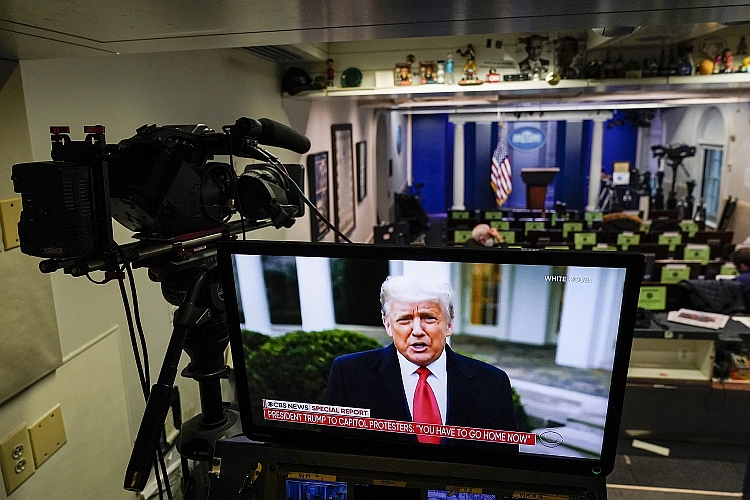 President Trump appears on a monitor in the White House briefing room depicting a video he released instructing rioters to go home.