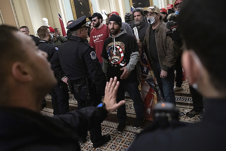 Doug Jensen and rioters confront police after storming the Capitol.