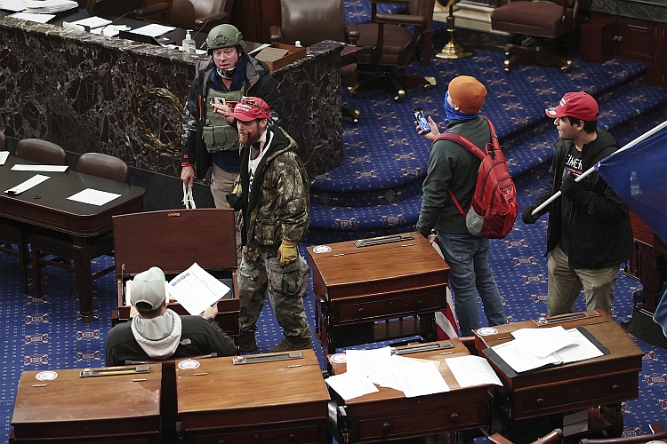 Rioters enter the Senate Chamber.