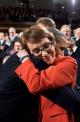 Hugging Rep. Gabrielle D. Giffords on the floor of the House Chamber prior to delivering the State of the Union Address at the U.S. Capitol, January 24.