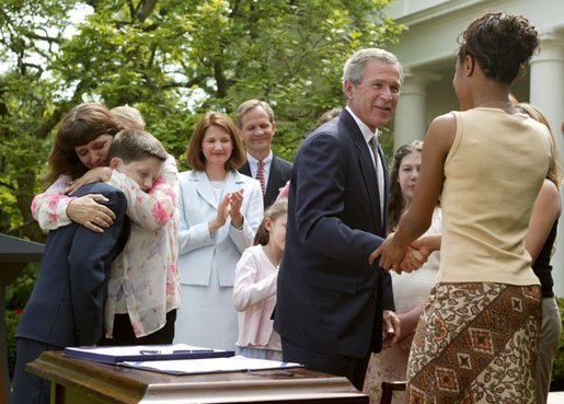 President George W. Bush greets Tamara Brooks after signing the S. 151, PROTECT Act of 2003, in the Rose Garden Wednesday, April 30, 2003. Brooks, 17, was rescued after an AMBER Alert was issued throughout Orange County, Calif., alerting the community of her abduction.