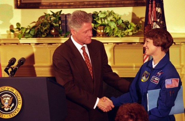 President Clinton shakes hands with Lt. Col. Eileen M. Collins in the Roosevelt Room after having announced her as the first woman space mission commander, 3/5/1998. (National Archives Identifier 183374036)