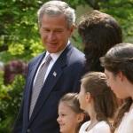 President George W. Bush looks toward Lacy Lyons, center, before signing the PROTECT Act of 2003, in the Rose Garden Wednesday, April 30, 2003. Lacy and her sister were found after an AMBER alert in Florida. Source: The White House Archives